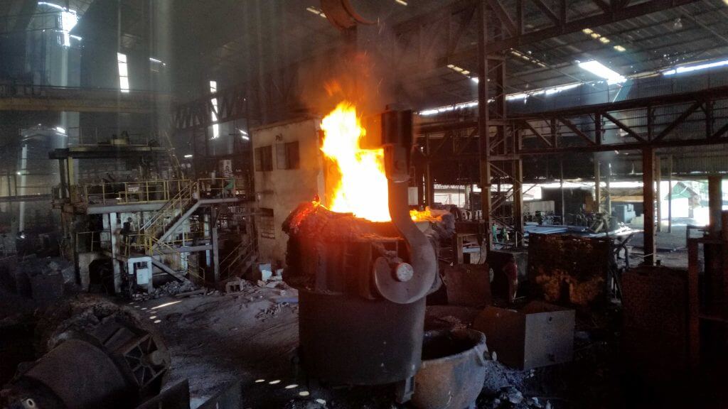 A photo from a fire coming out from a machine at an industrial site.