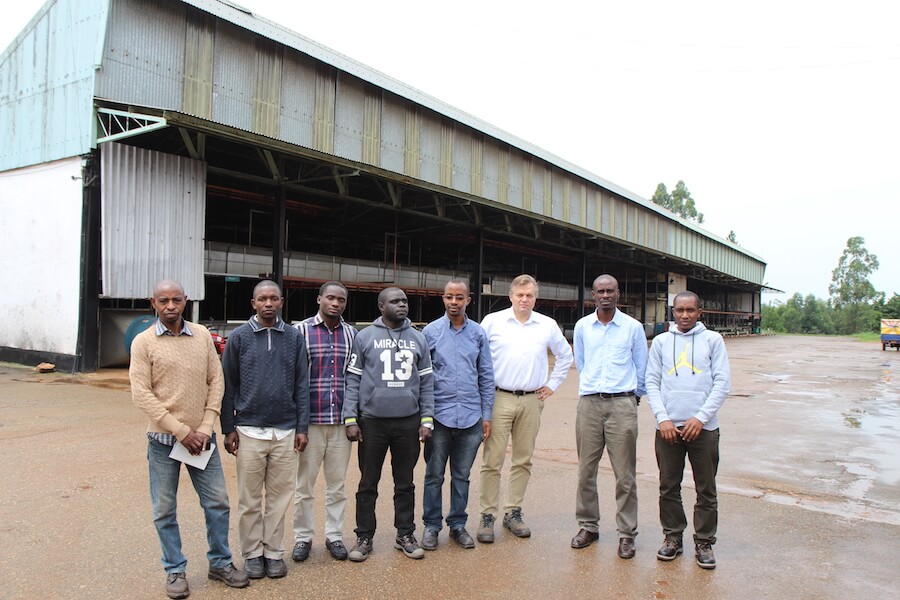 A group photo of the people who participated in the Envidatec Energy Efficiency project in front of a building in Uganda.